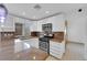 Galley kitchen featuring white cabinets, granite countertops, modern appliances, and tile floors at 738 Panhandle Dr, Henderson, NV 89014