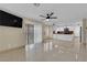 An empty living room features tile flooring, a ceiling fan, and sliding glass door at 738 Panhandle Dr, Henderson, NV 89014