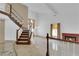 Bright, open living room with staircase, fireplace, and tile floors at 738 Panhandle Dr, Henderson, NV 89014
