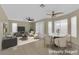 Open-plan living area with modern furniture, ceiling fans, and many windows at 738 Panhandle Dr, Henderson, NV 89014