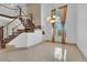 An open-plan living area featuring a high ceiling, large sunlit windows, and adjacent staircase with decorative railings at 738 Panhandle Dr, Henderson, NV 89014