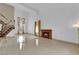 Bright living room showcasing a fireplace, high ceilings, large windows, and staircase with decorative railings at 738 Panhandle Dr, Henderson, NV 89014