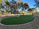 Spacious backyard featuring a putting green and ample space for outdoor activities at 7436 Oak Grove Ave, Las Vegas, NV 89117