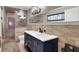 Elegant bathroom featuring a double vanity with marble countertops, a large mirror, and a glass-enclosed shower at 7436 Oak Grove Ave, Las Vegas, NV 89117