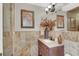 Bathroom featuring travertine tile, a single vanity, and a step-in shower at 7436 Oak Grove Ave, Las Vegas, NV 89117