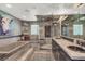 This well-lit bathroom features dual sinks, a stand-up shower, and decorative artwork at 7436 Oak Grove Ave, Las Vegas, NV 89117