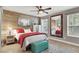 Charming bedroom with wood paneling, a comfortable bed, and a decorative mirror reflecting the room at 7436 Oak Grove Ave, Las Vegas, NV 89117