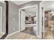 Hallway showcasing tile flooring, leading to a bedroom and a bathroom with glass shower at 7436 Oak Grove Ave, Las Vegas, NV 89117