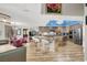 Open kitchen and living area featuring stainless steel appliances, large island, and bright lighting at 7436 Oak Grove Ave, Las Vegas, NV 89117
