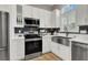This spacious kitchen offers stainless steel appliances, including a refrigerator, range, and microwave at 7436 Oak Grove Ave, Las Vegas, NV 89117