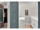 Laundry area with a white washer and dryer, custom cabinets, and an entry to the walk-in closet at 7436 Oak Grove Ave, Las Vegas, NV 89117