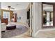 Bright living room with a stone accent wall, plush ottoman, and a view into another room through an open doorway at 7436 Oak Grove Ave, Las Vegas, NV 89117