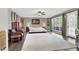Large main bedroom with ceiling fan, sitting area, and a view of the pool at 7436 Oak Grove Ave, Las Vegas, NV 89117
