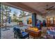 Covered patio featuring a built-in fire pit, pool, and outdoor seating area at 7436 Oak Grove Ave, Las Vegas, NV 89117