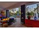 Covered outdoor patio with a built-in fire pit and a partial view of the pool at 7436 Oak Grove Ave, Las Vegas, NV 89117