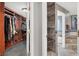 Walk-in closet features custom shelving and connects to the bathroom and the main bedroom at 7436 Oak Grove Ave, Las Vegas, NV 89117
