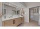 Elegant bathroom with a double vanity, a large mirror and a sliding door to the walk-in closet at 7711 Spanish Lake Dr, Las Vegas, NV 89113