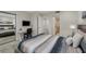 Comfortable bedroom with a plush bed, mirrored closet, and ensuite bathroom at 7711 Spanish Lake Dr, Las Vegas, NV 89113