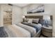 Stylish bedroom featuring a plush bed with designer linens, bedside tables and lamps at 7711 Spanish Lake Dr, Las Vegas, NV 89113