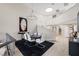Elegant dining area with modern chandelier, neutral tones, and spiral staircase at 7711 Spanish Lake Dr, Las Vegas, NV 89113