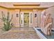 Elegant home entrance with stone fountain, modern lighting, and tiled walkway at 7711 Spanish Lake Dr, Las Vegas, NV 89113
