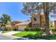 Charming home boasts a two-car garage, mature landscaping, and a red tile roof at 7711 Spanish Lake Dr, Las Vegas, NV 89113
