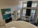 Upstairs view of the open floor plan living room with a fireplace and pool view at 7711 Spanish Lake Dr, Las Vegas, NV 89113