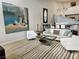 Bright living room with a modern fireplace, neutral color palette, and large art piece at 7711 Spanish Lake Dr, Las Vegas, NV 89113