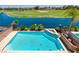 Beautiful pool with a serene lake and golf course in the background at 7711 Spanish Lake Dr, Las Vegas, NV 89113