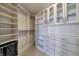 Spacious walk-in closet boasts custom shelving, drawers, and cabinets providing ample storage space and organization at 7711 Spanish Lake Dr, Las Vegas, NV 89113