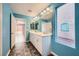 Bright bathroom with double sink vanity, modern lighting fixtures, and ensuite layout at 7745 Tyrell Peaks St, Las Vegas, NV 89139