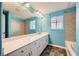 Bathroom with a wide mirror, blue walls, double vanity, and a separate shower and tub at 7745 Tyrell Peaks St, Las Vegas, NV 89139