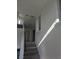 Bright hallway featuring neutral paint and carpeted stairs leading to upper level at 7745 Tyrell Peaks St, Las Vegas, NV 89139