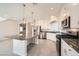 Bright kitchen featuring white cabinets, stainless steel appliances, granite countertops, and pendant lighting at 7745 Tyrell Peaks St, Las Vegas, NV 89139
