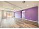 Spacious living room features modern light fixtures, ceiling fan, and hardwood flooring at 7745 Tyrell Peaks St, Las Vegas, NV 89139