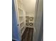 Walk-in pantry with custom built-in shelving and hardwood floors at 7745 Tyrell Peaks St, Las Vegas, NV 89139