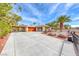 Spacious driveway with mature landscaping leading to a charming single-story home with a carport at 7748 Firethorn Ln, Las Vegas, NV 89123