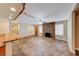 Open living room with tile flooring, exposed brick fireplace, and natural light at 7748 Firethorn Ln, Las Vegas, NV 89123