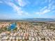 Stunning aerial shot showcasing a lakeside community with palm trees and homes nestled by the water at 8005 Dover Shores Ave, Las Vegas, NV 89128