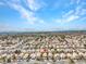 Expansive aerial view of a well-planned community with houses featuring light-colored roofs under a bright sky at 8005 Dover Shores Ave, Las Vegas, NV 89128