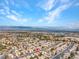 Wide aerial photo exhibiting a large community with consistent housing designs, set under a vibrant sky at 8005 Dover Shores Ave, Las Vegas, NV 89128
