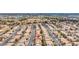 Scenic aerial shot of a uniform neighborhood, showcasing neat rows of houses under a clear, bright sky at 8005 Dover Shores Ave, Las Vegas, NV 89128