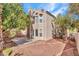 Spacious backyard features low-maintenance desert landscaping, mature trees, and a paved patio at 8005 Dover Shores Ave, Las Vegas, NV 89128
