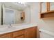 Bathroom with a single sink, a light wood vanity, and a mirror at 8005 Dover Shores Ave, Las Vegas, NV 89128