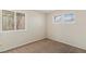 Cozy bedroom with carpet flooring, two windows providing natural light, and neutral color scheme at 8005 Dover Shores Ave, Las Vegas, NV 89128