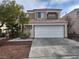 Charming two-story home showcasing a tile roof, neutral color palette, desert landscaping and attached garage at 8005 Dover Shores Ave, Las Vegas, NV 89128