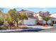 Inviting two-story home boasts a spacious driveway and desert-friendly yard at 8005 Dover Shores Ave, Las Vegas, NV 89128