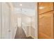 Upstairs hallway features carpet floors, light walls, and wood cabinets for linen and storage at 8005 Dover Shores Ave, Las Vegas, NV 89128