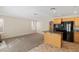 Well-lit kitchen area with a center island, black appliances, and a cozy fireplace in the background at 8005 Dover Shores Ave, Las Vegas, NV 89128