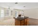 Bright eat-in kitchen featuring a center island, ceiling fan, and a door leading to the backyard at 8005 Dover Shores Ave, Las Vegas, NV 89128